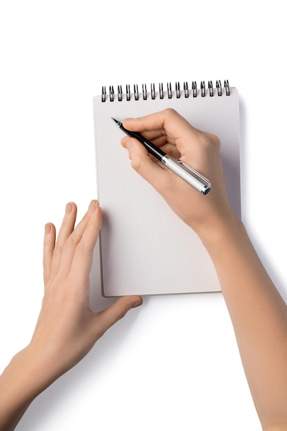 Photo woman's holding pen and writing in notebook