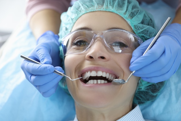 Woman's oral cavity is examined at dentist's office