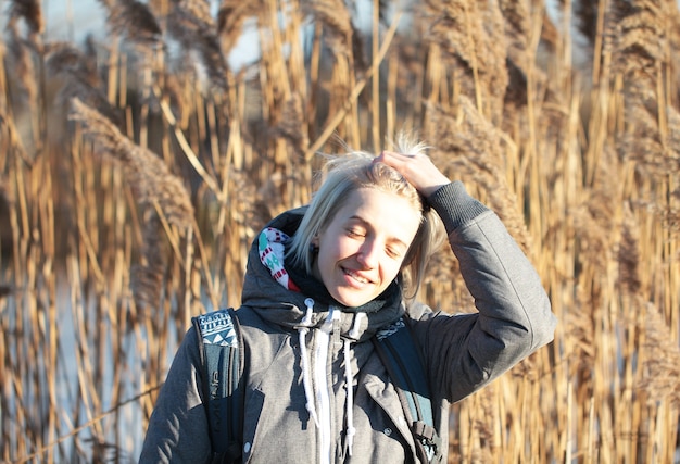 Woman's sunny portrait at the reeds background