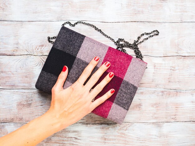 Woman's winter clutch on wooden table