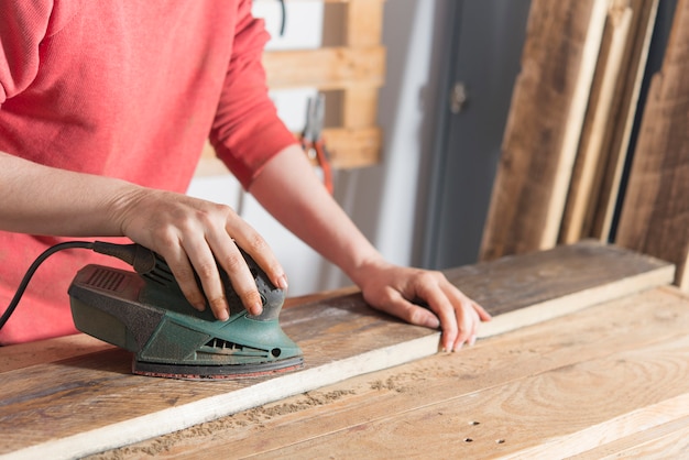 Woman sanding a restored wood