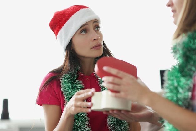 Woman in santa claus hat open empty box no present sad facial expression