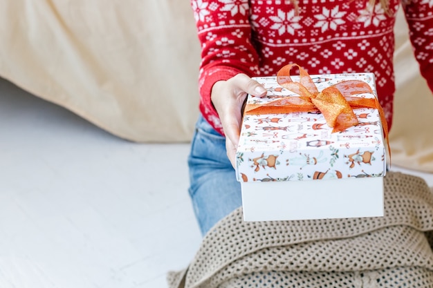 Woman in Santa hat holding a gift