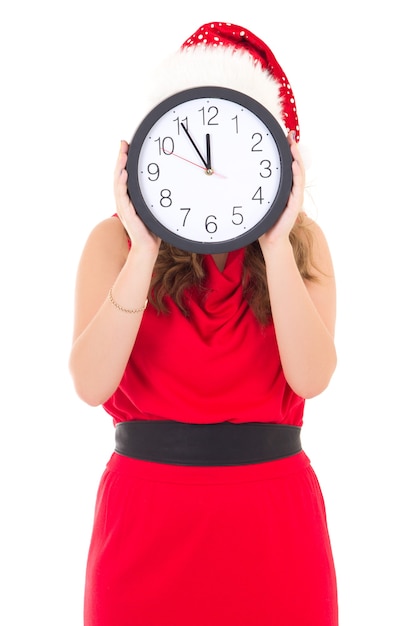 Woman in santa hat with clock posing isolated on white background