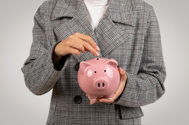 Woman saving money in a piggy bank