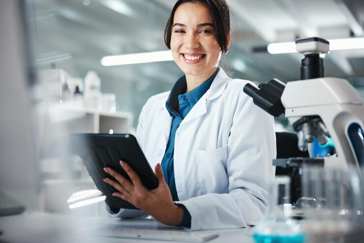 Photo woman scientist and portrait with tablet in lab for microscope research medical data and science information smile researcher and digital for study feedback vaccine solution and biotechnology
