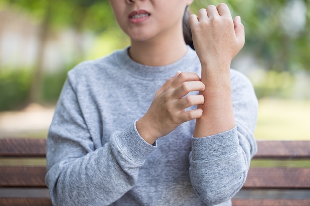 Woman scratching her skin