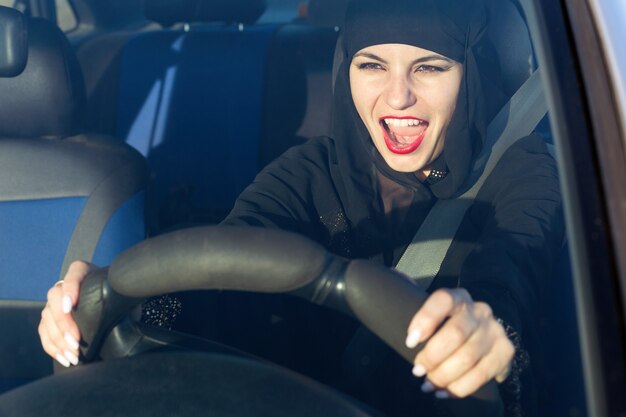 Photo woman screaming singing songs while driving a car.