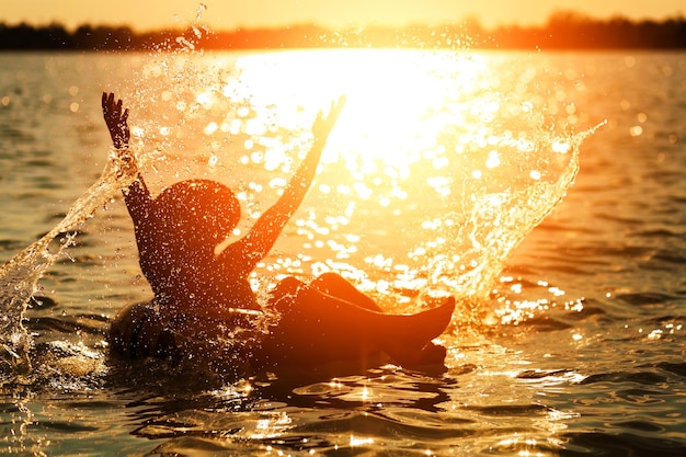 Foto donna in mare contro il cielo durante il tramonto