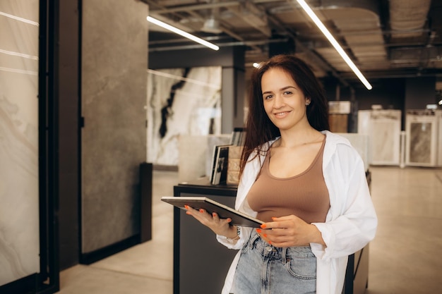 Woman selecting kitchen tile in store