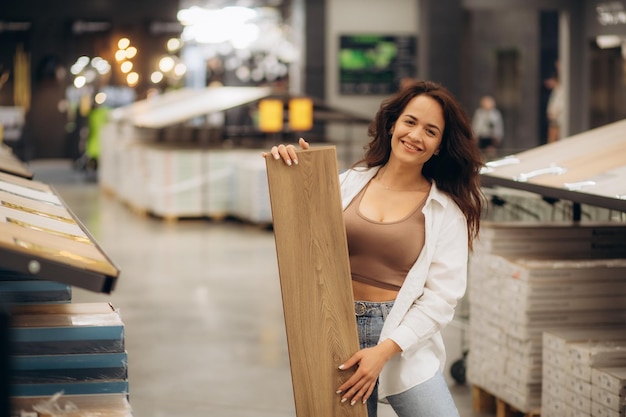 Woman seller advises a buyer in choosing a laminate in a hardware store High quality photo