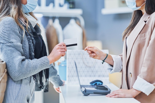 Woman seller and buyer in clothes store. High quality photo