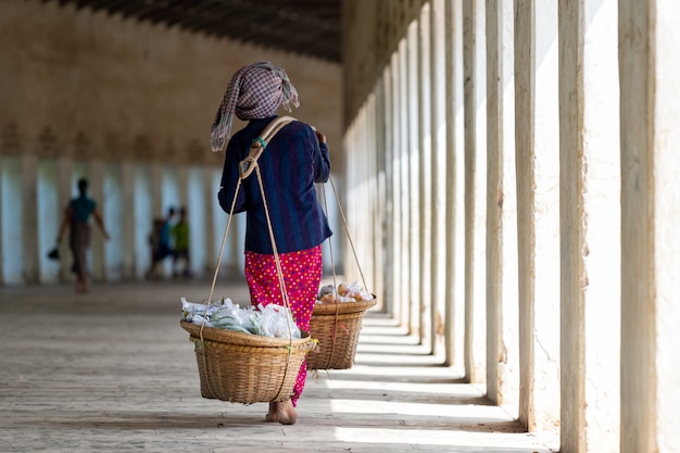 Woman selling fruit from baskets