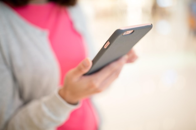 Woman sending sms on mobile phone