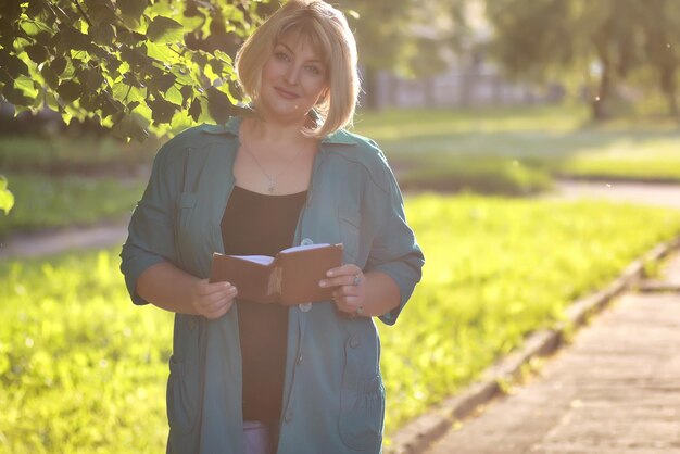 Woman senior in park with book