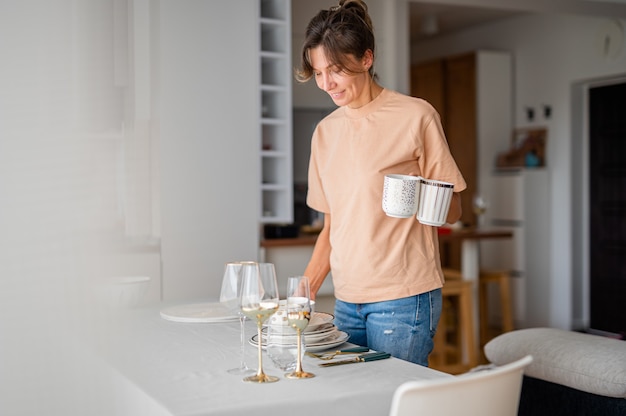 woman sets the table and prepares for dinner