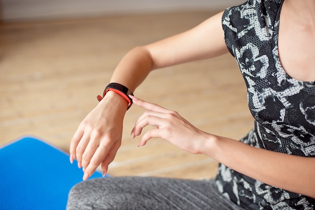 Photo woman setting up the fitness smart watch for running.