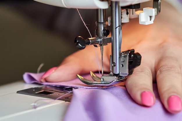 Woman sewing a dress on a sewing machine