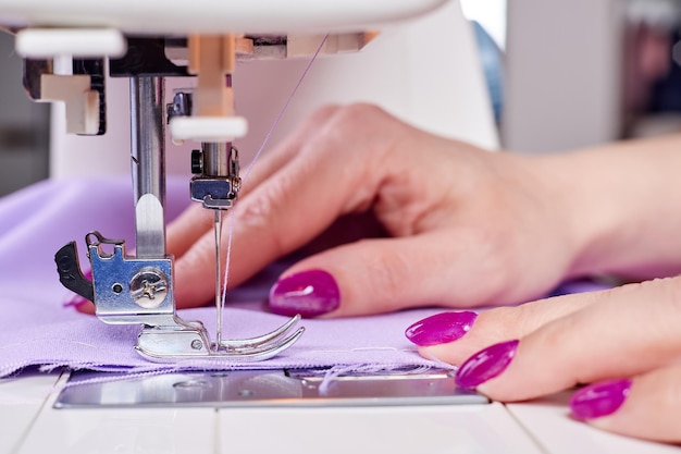 Woman sewing a dress on a sewing machine