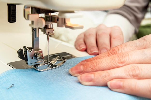 Woman sews on a sewing machine