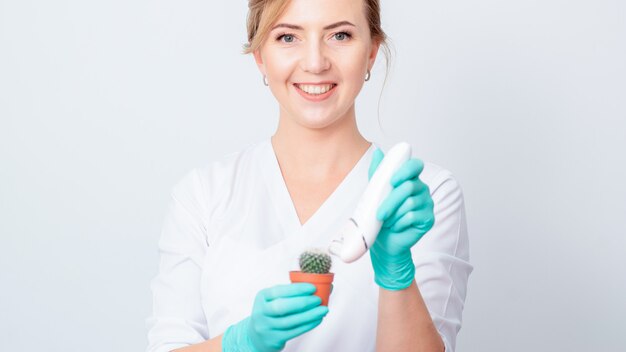 Woman shaves green cactus.