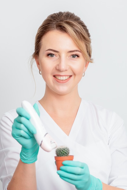 Woman shaves green cactus.