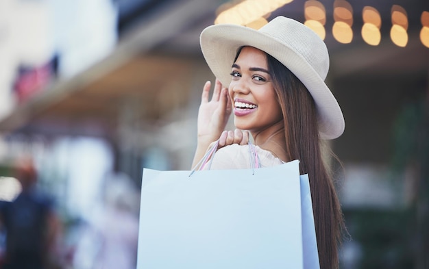 Woman shopping bag and portrait smile in the city carrying bags for discount deal or purchase Happy female shopper smiling in joyful happiness for luxury fashion gifts or sale in an urban town