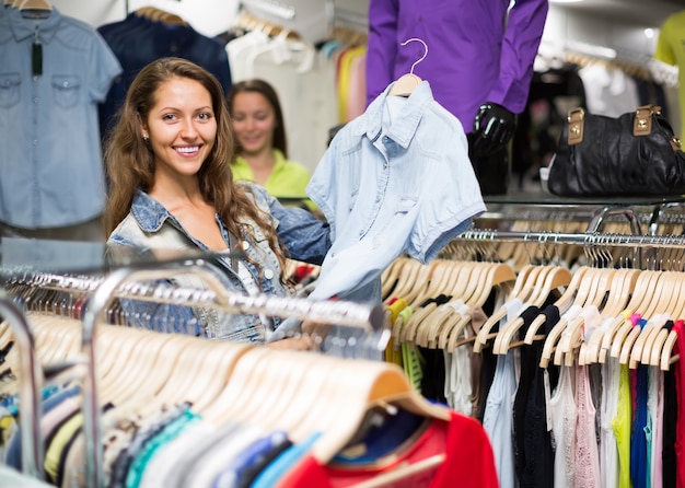 Woman shopping blouse in clothing store&#xA;