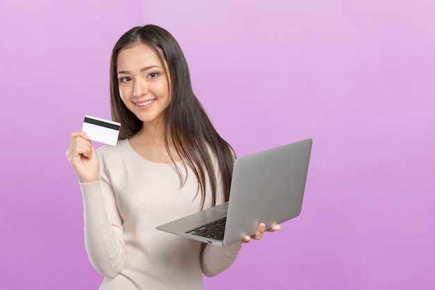 Woman shopping on computer with credit card