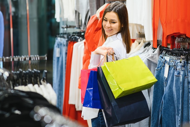 woman in shopping. happy woman with shopping bags enjoying in shopping. consumerism, shopping, lifestyle concept