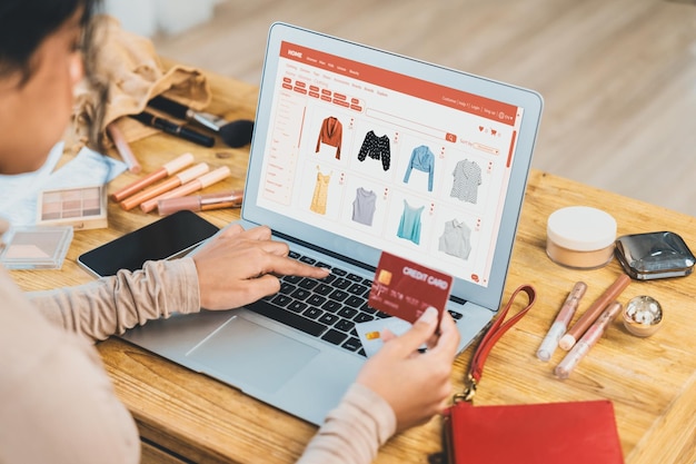 Woman shopping online on internet marketplace browsing for sale items for modern lifestyle and use credit card for online payment from wallet protected by crucial cyber security software