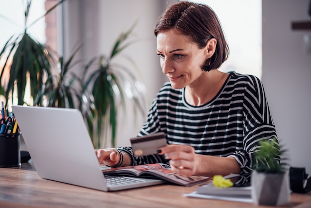 Woman shopping online and using credit card