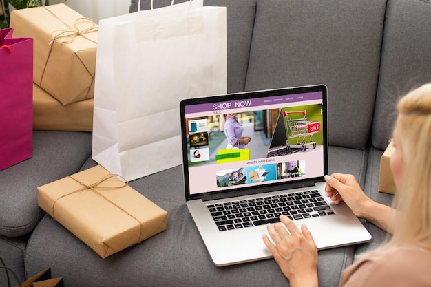 Woman shopping online using her laptop at home.