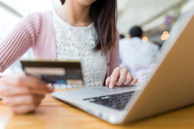 Woman shopping with credit card and laptop computer