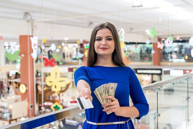 Woman on shopping with dollars and credit card