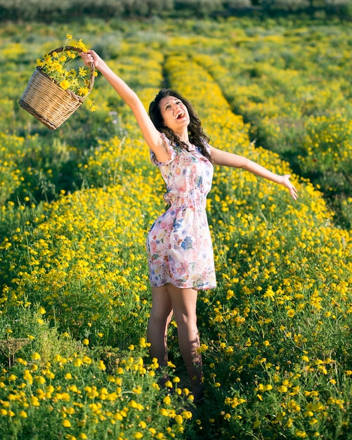 Woman shout happy among yellow daisies