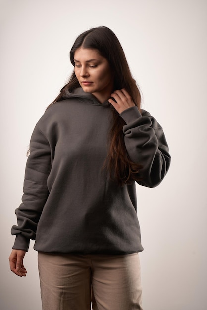 Woman Showcasing a Black Hoodie for Logo Branding Streetwear clothing mockup Logo on shirt template copy space