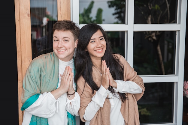 Woman showing asian greeting gesture