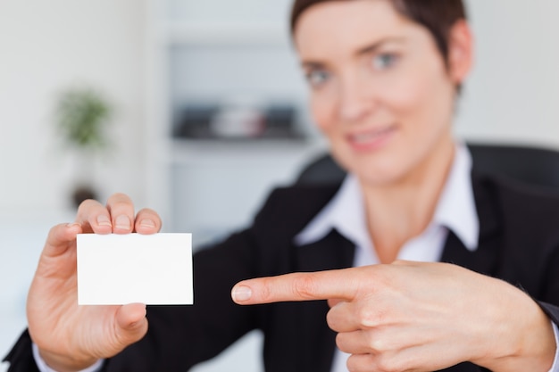 Woman showing a blank business card