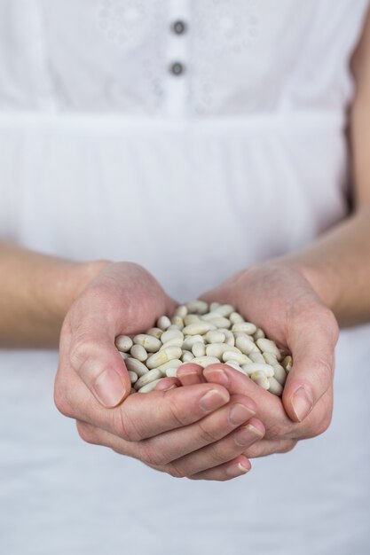 Woman showing handful of lima beans