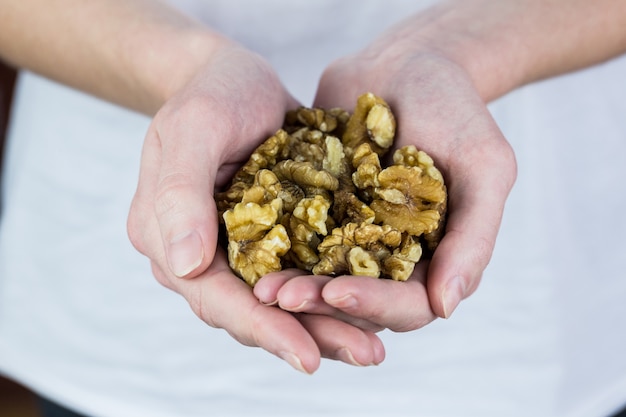 Woman showing handful of walnuts