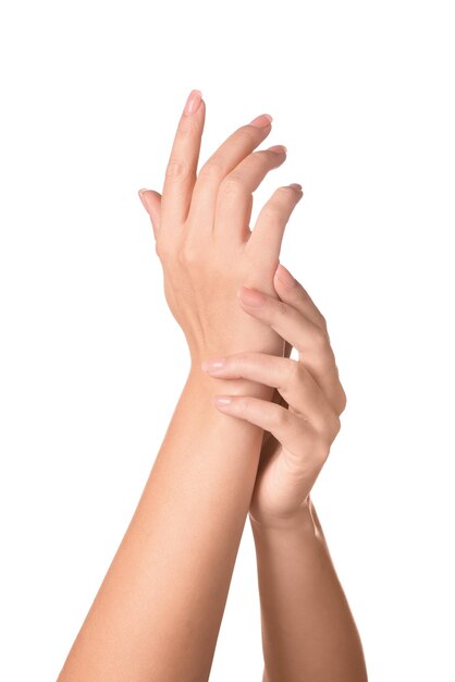 Woman showing hands with nude manicure on white background closeup