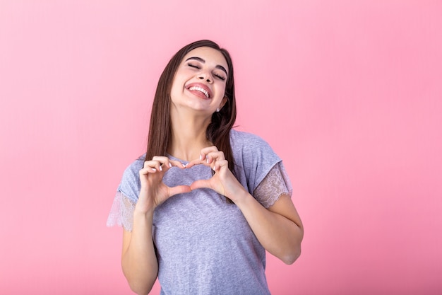 woman showing heart gesture with two hands