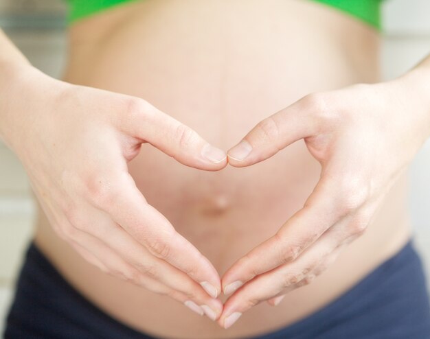 Woman showing heart shape hand gesture