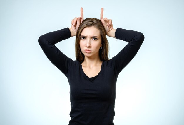 Woman showing horns with her fingers