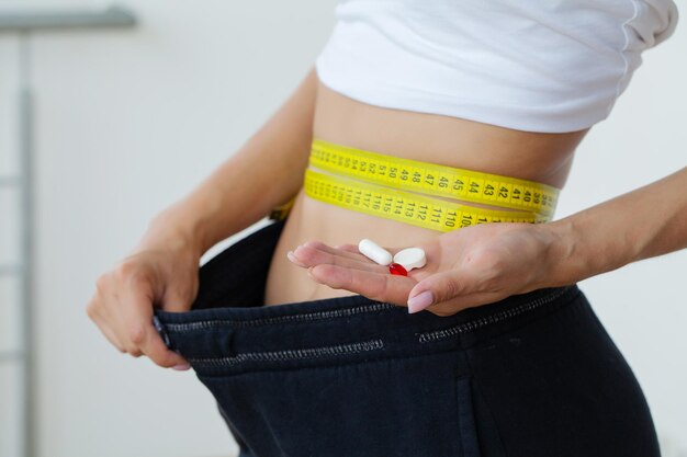 Woman showing how much weight she lost