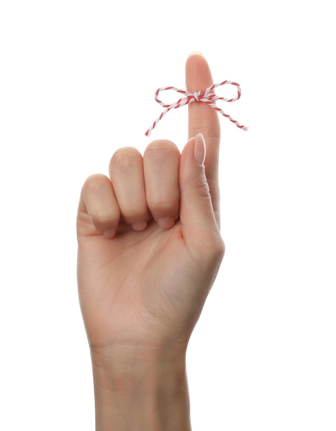 Woman showing index finger with tied bow as reminder on white background closeup