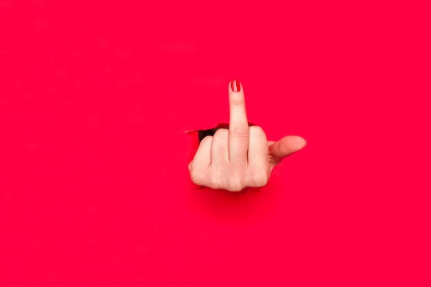 Photo woman showing middle finger in hole