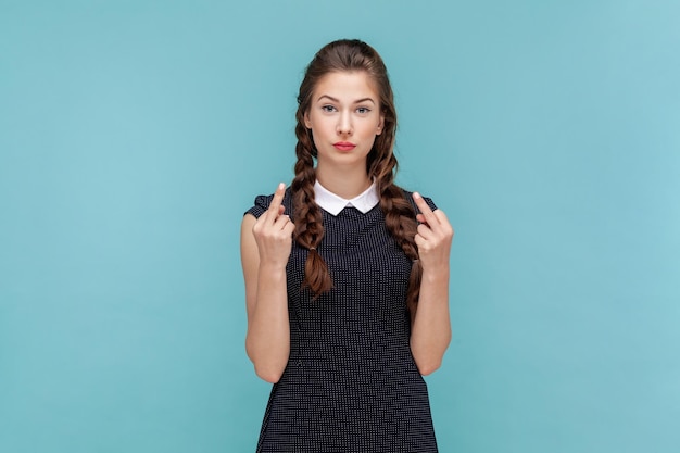 Woman showing middle finger impolite gesture disrespects someone looks rude at camera