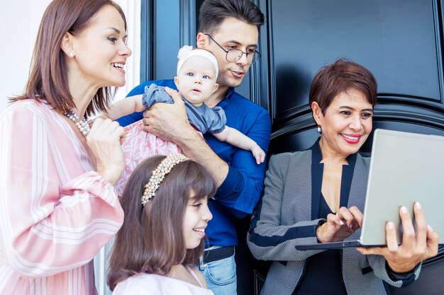 Woman showing an offer in her laptop to the family